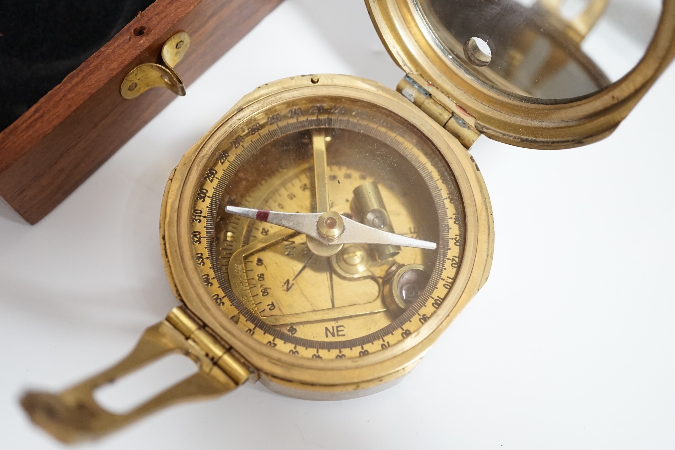 A gilt metal circular pocket barometer by Gallagher and Co., New Bond Street, London (lacks case) and a reproduction solid brass Brunton nautical compass in wooden box